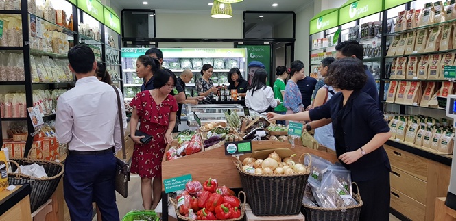 Vietnamese consumers shopping from clean food store Organica in Hanoi