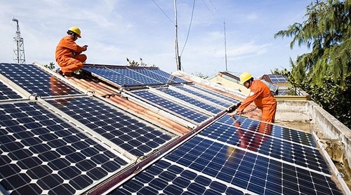 Workers working on rooftop solar panels in Vietnam