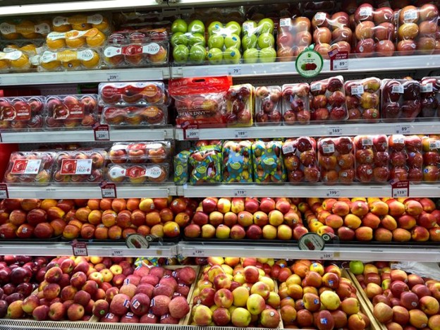 Imported fruits with labels and quality marks in supermarket stalls