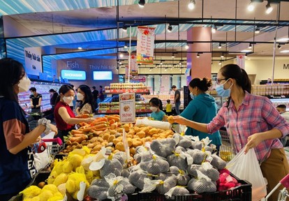 Consumers at vegetable counter in a large supermarket in Vietnam